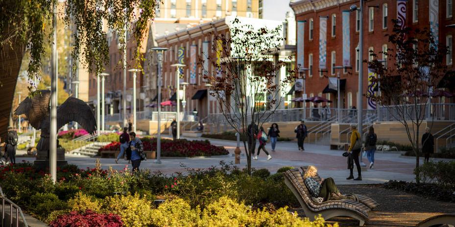 Students walking across Liacouras Walk on a sunny day